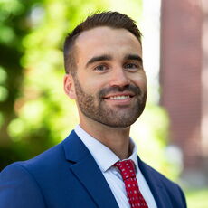 A person poses for a headshot.