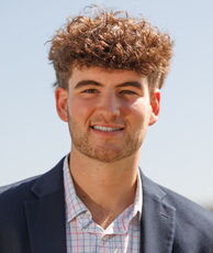A person poses for a headshot.