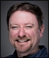 A person poses for a headshot.