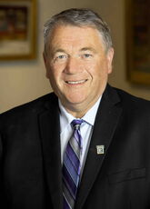 A person poses for a headshot.