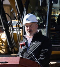 A person stands at a lectern.