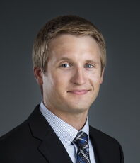 A person poses for a headshot.