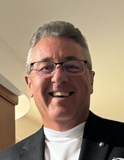 A person poses for a headshot.