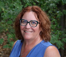 A person poses for a headshot.