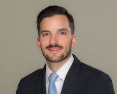 A person poses for a headshot.