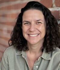 A person poses for a headshot.