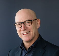 A person poses for a headshot.