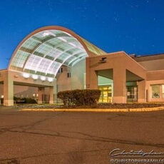 An exterior view of a building with an arch.