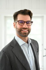 A person poses for a headshot.