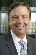 A person poses for a headshot.