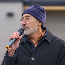 man speaks at microphone