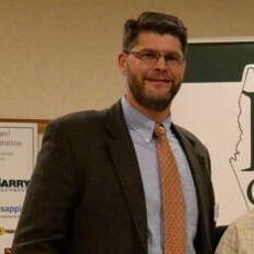 A person poses for a headshot.