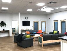 A room has chairs, a ccouch and a table.