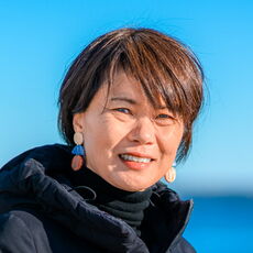 Asian woman in front of water