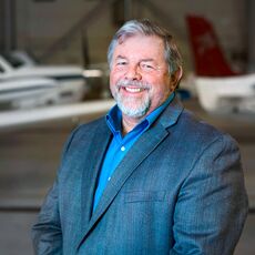 Steve Levesque with planes in the background.