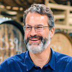 Rob Tod in front of barrels