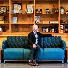 Carlos Mello seated on a couch