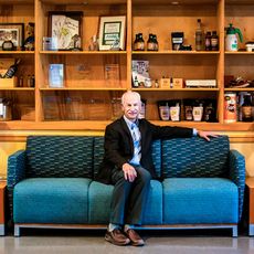 Carlos Mello seated on a couch 