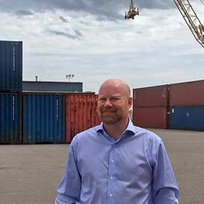 Jonathan Nass at IMT with cranes and containers in the background 