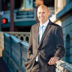 Portrait of man standing outdoors in a suit