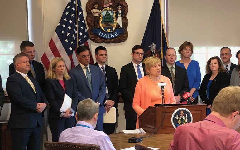 Governor Janet Mills with cabinet behind her