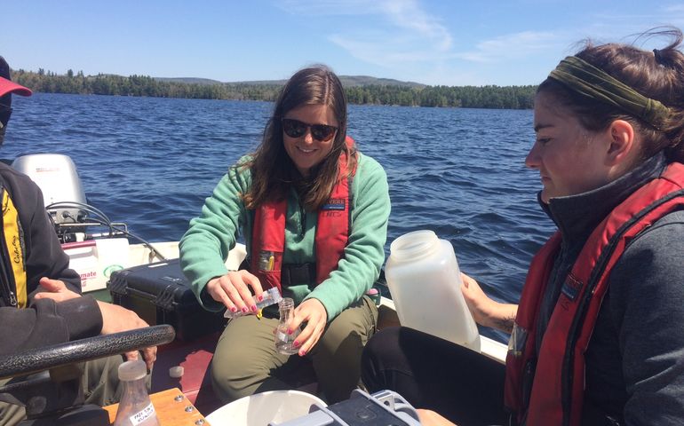 People on a boat taking water samples