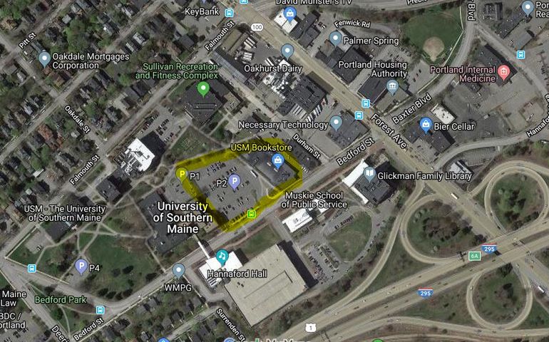 An overhead map showing the campus of the University of Southern Maine with one area, including a building and parking lot,highlighted in yellow.