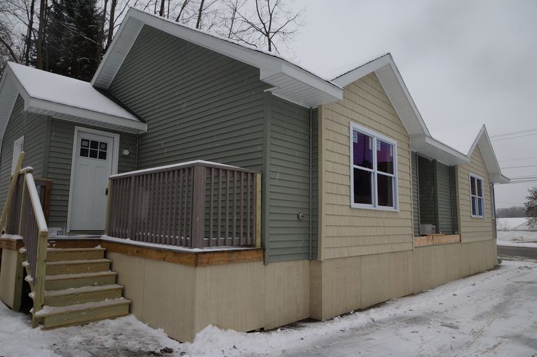 A one-story house on a snowy street