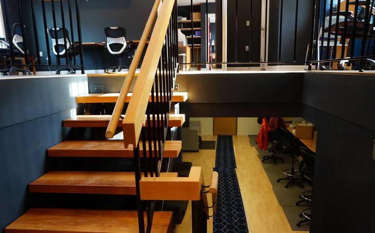 A view of staircase in a split level office, with working space on on both levels