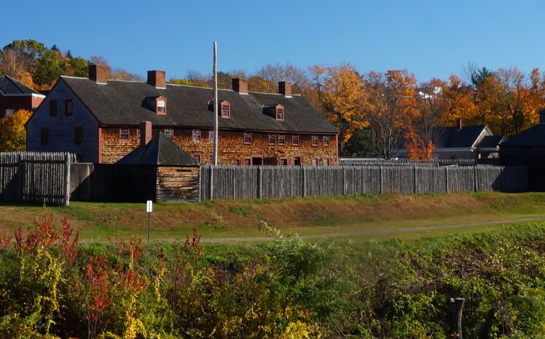 An old wooden fort on a riverbank