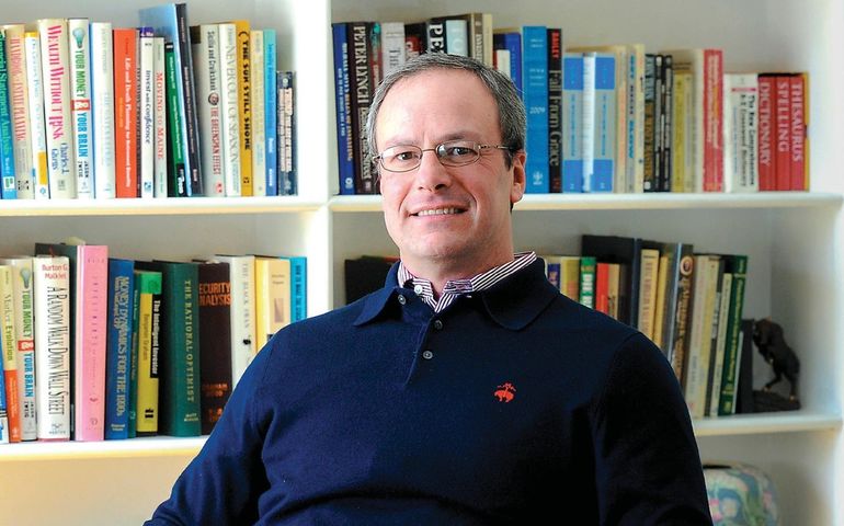 Brian Bernathez in his office (seated, in front of book shelves)