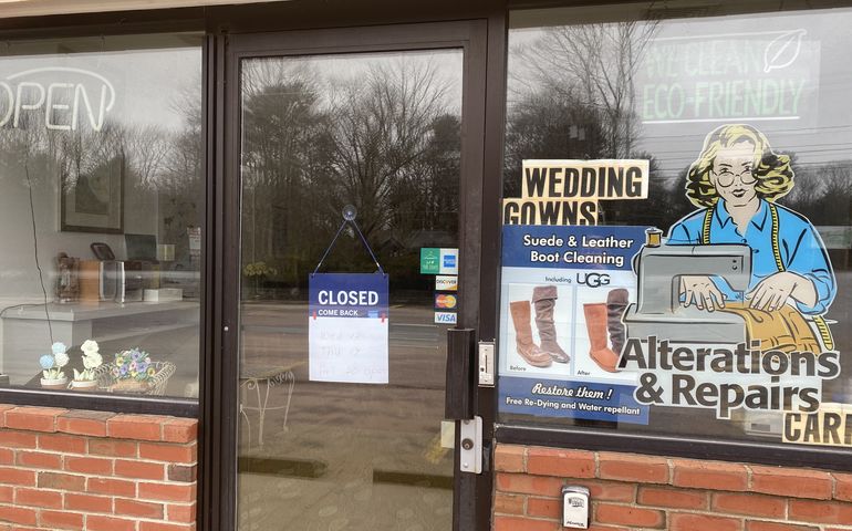 Store with a 'closed' sign in the window.