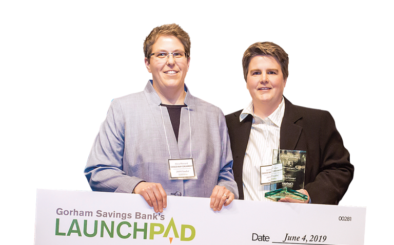 2019 LaunchPad winners Alicia Menard and Jennell Carter holding an oversized check for $50,000.