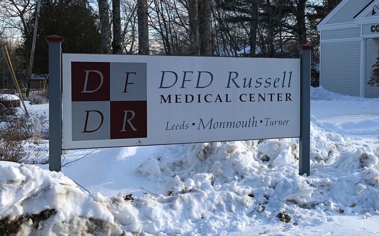 A sign in the snow that says DFD Russell Medical Center Leeds Monmouth Turner