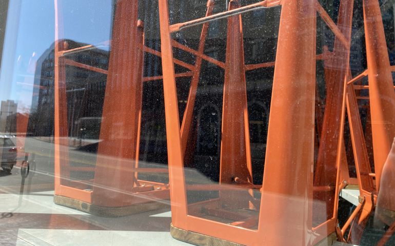 Upside down chairs in a closed coffee shop.