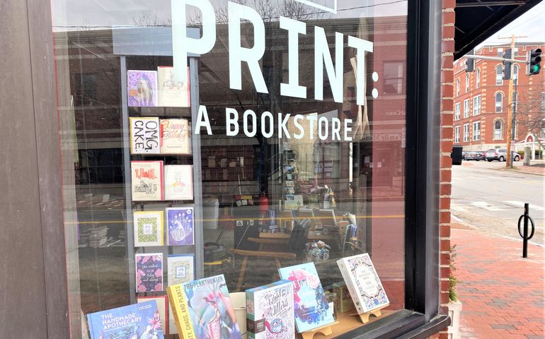 The storefront of a bookstore showing books in the window