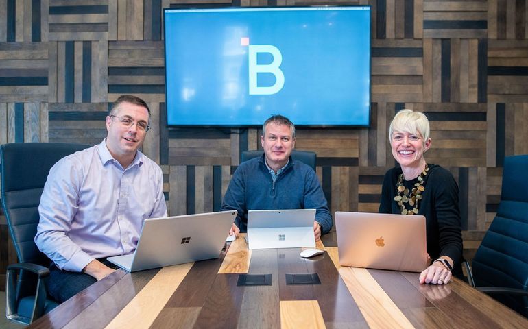 HighByte three co-founders seated at a table with laptops