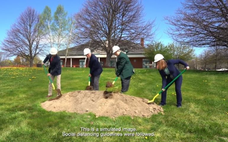 Screen shot of people shoveling dirt 