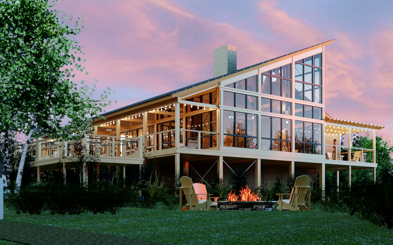 Exterior of a modern lodge building, showing a campfire and tree outside.