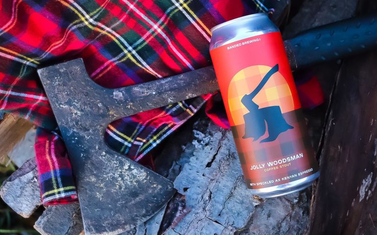 Photo of Jolly Woodsman beer can plus lumberjack shirt and an ax 