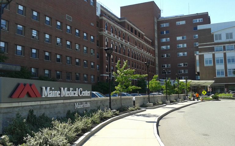 driveway leading to entrance of multistory brick building complex