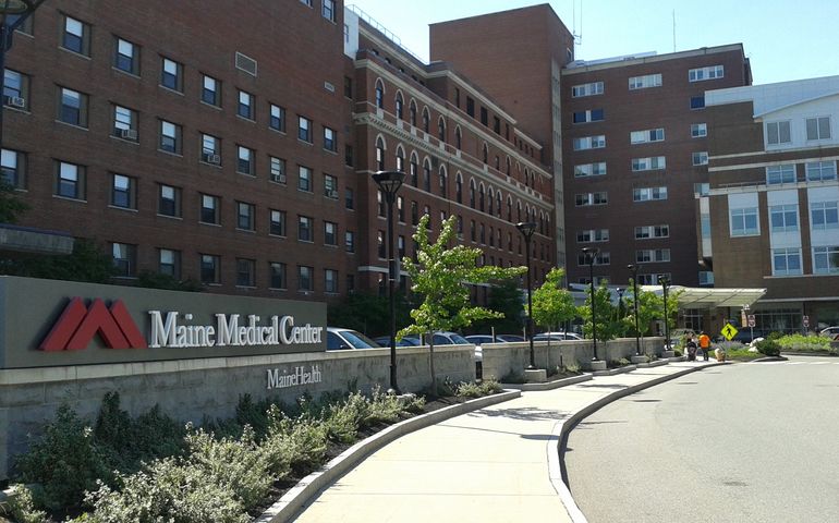 driveway leading to entrance of multistory brick building complex