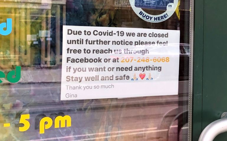a close up of a sign on the door of a business that says "due to covid-19 we are closed until further notice