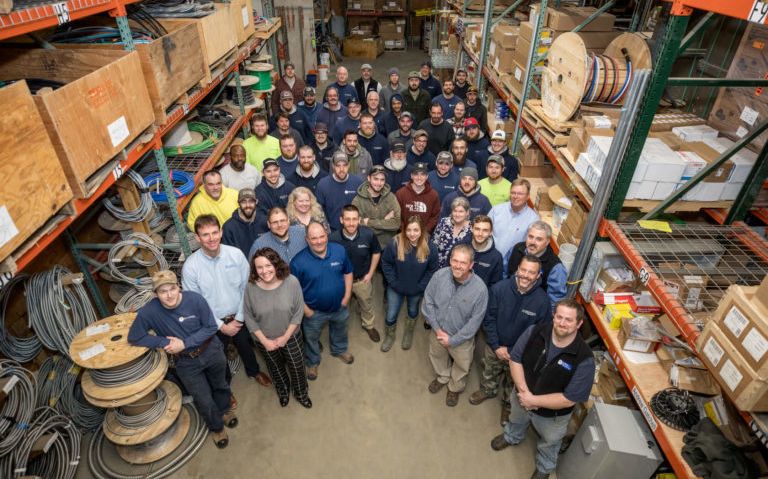 dozens of workers in warehouse, photographed from above