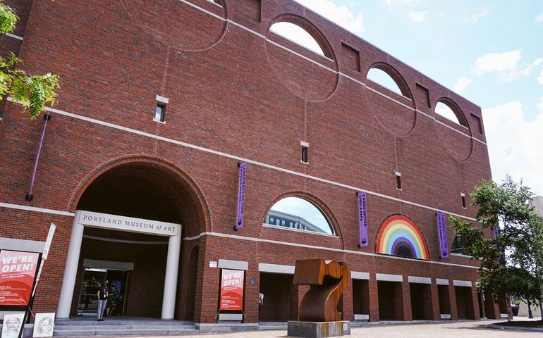 exterior of modern brick building with "7" sculpture