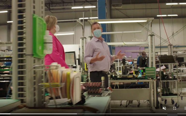 screenshot of man and woman in manufacturing plant