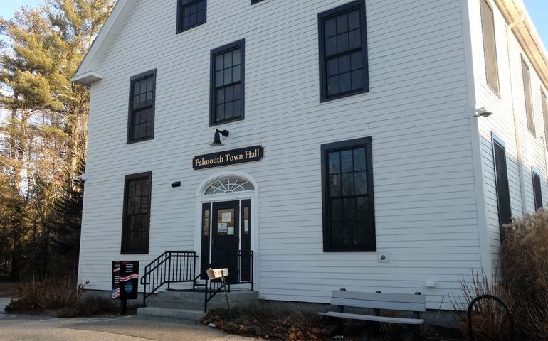 white farmhouse-style building, with falmouth town hall sign