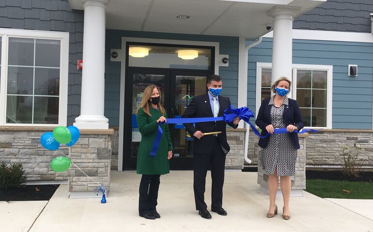 Three people at ribbon cutting ceremony 