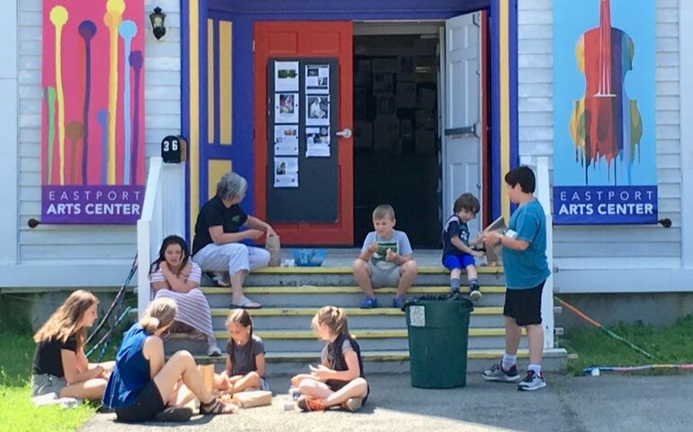 photo of kids having lunch outside arts center