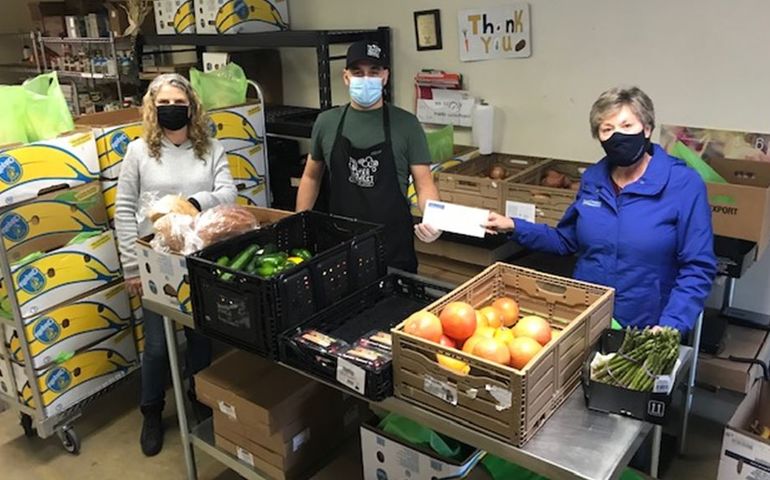 Locker project volunteers with food being sorted